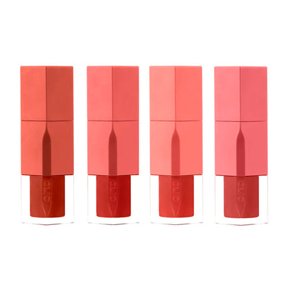 Four lipsticks in different shades of red and pink on a white background