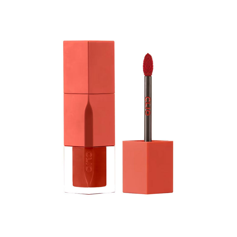 Red lipstick with applicator and packaging on a white background