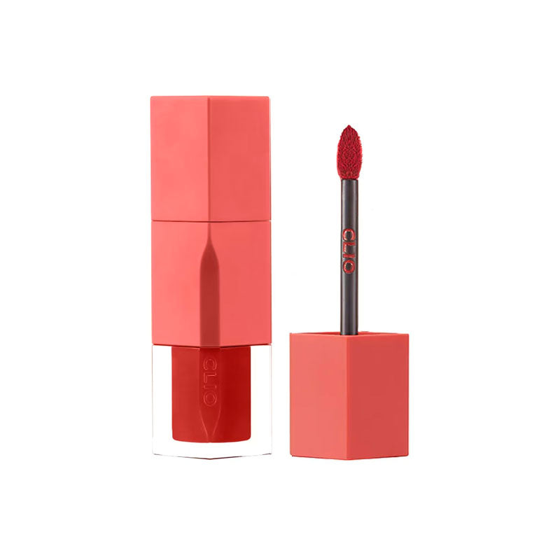 Red lipstick with applicator on a white background